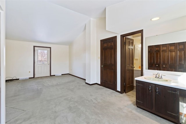 bathroom with vanity and vaulted ceiling