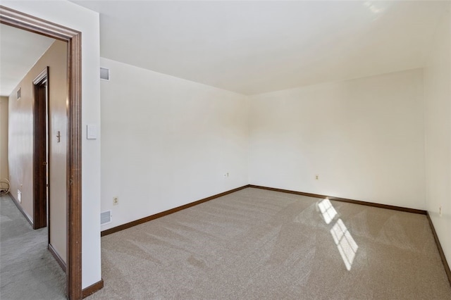 unfurnished room with light colored carpet