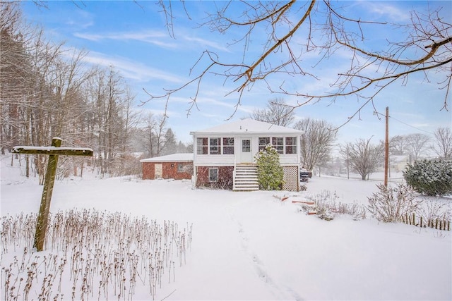 view of front of house with a sunroom