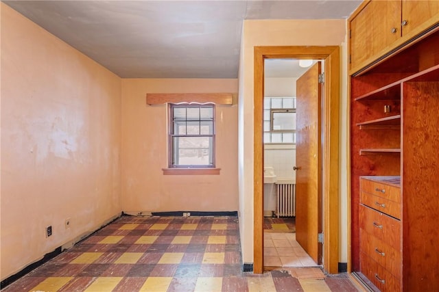 unfurnished room featuring radiator