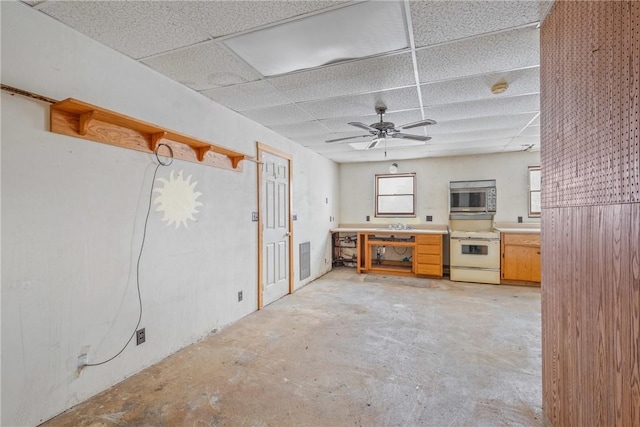 kitchen featuring a healthy amount of sunlight, a paneled ceiling, ceiling fan, and white range with electric stovetop