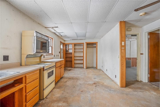 kitchen featuring a paneled ceiling and white range with electric cooktop