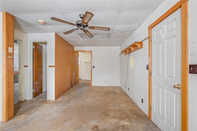 empty room with a drop ceiling and ceiling fan