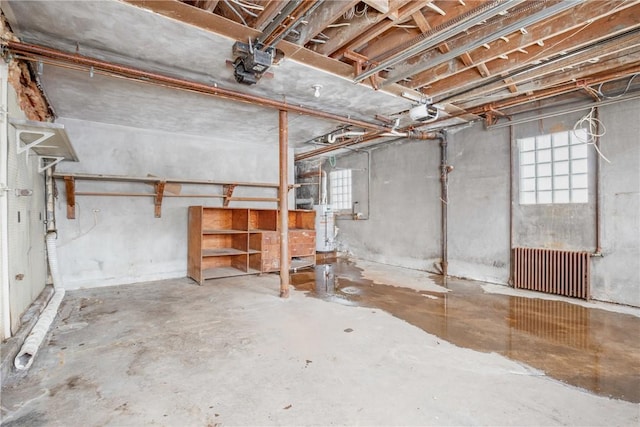 basement with radiator and water heater