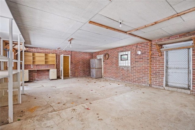 interior space with concrete floors and brick wall