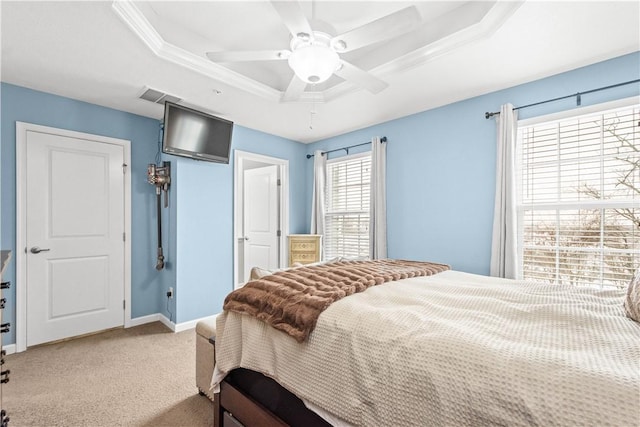 bedroom with crown molding, light carpet, ceiling fan, and a tray ceiling