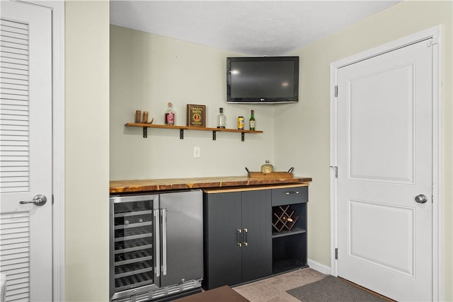 bar with wine cooler, dark carpet, and butcher block countertops