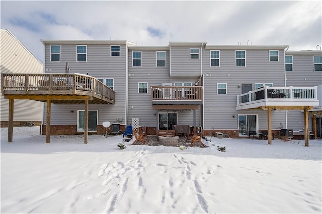 snow covered house featuring central AC