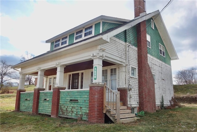 view of side of property with a porch