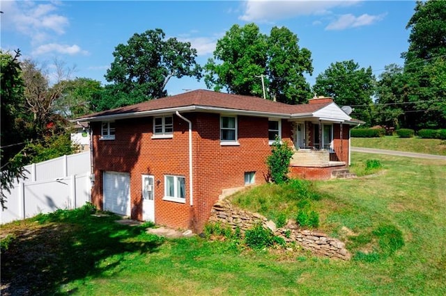 exterior space with a garage and a front lawn