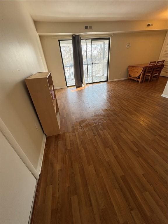 unfurnished room with dark hardwood / wood-style flooring