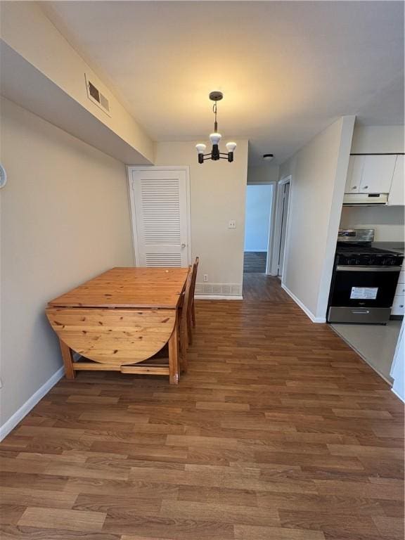 dining area with a notable chandelier and wood-type flooring