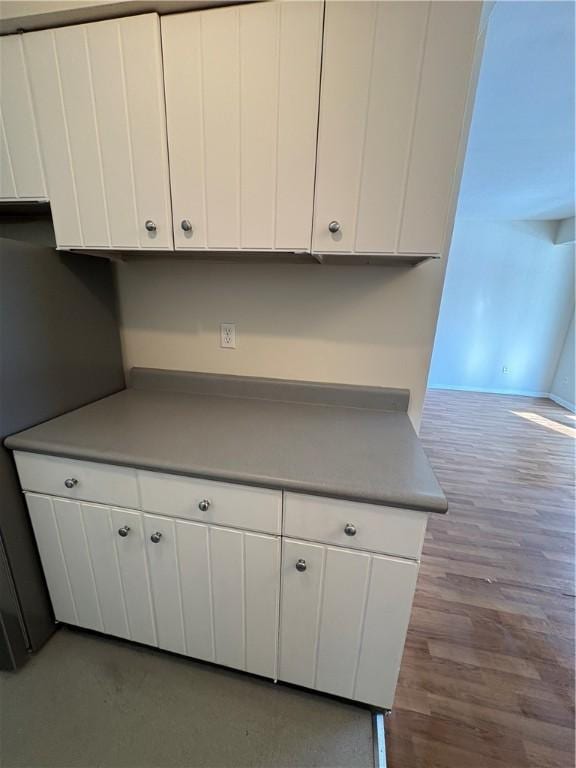 kitchen featuring light hardwood / wood-style flooring and white cabinets