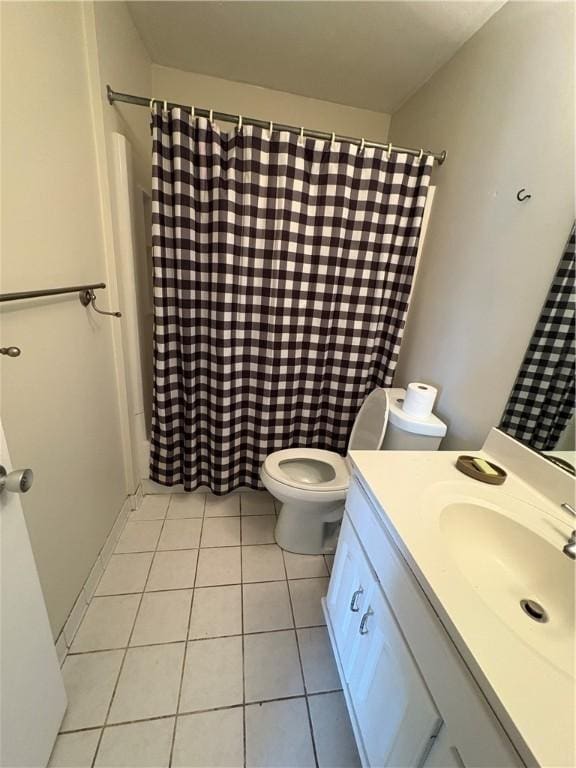 full bathroom featuring vanity, tile patterned floors, toilet, and shower / bath combo with shower curtain