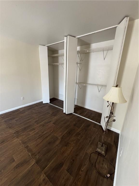 unfurnished bedroom featuring dark hardwood / wood-style flooring