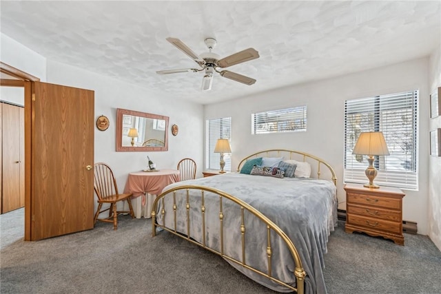 bedroom with ceiling fan and dark colored carpet