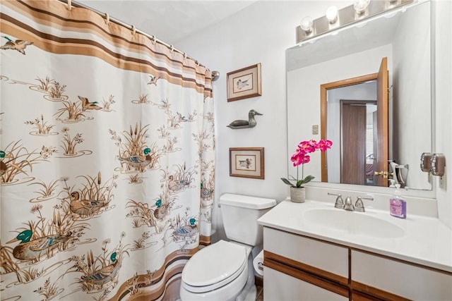 bathroom featuring vanity, curtained shower, and toilet