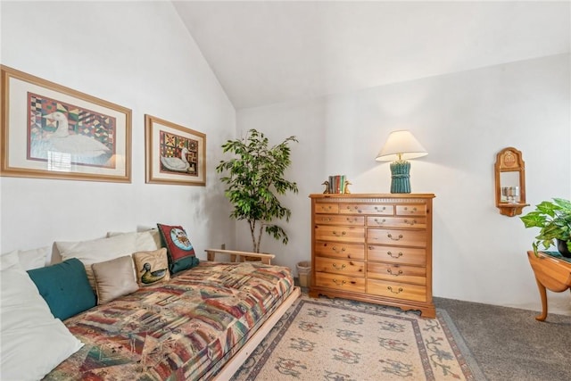 bedroom with carpet floors and vaulted ceiling