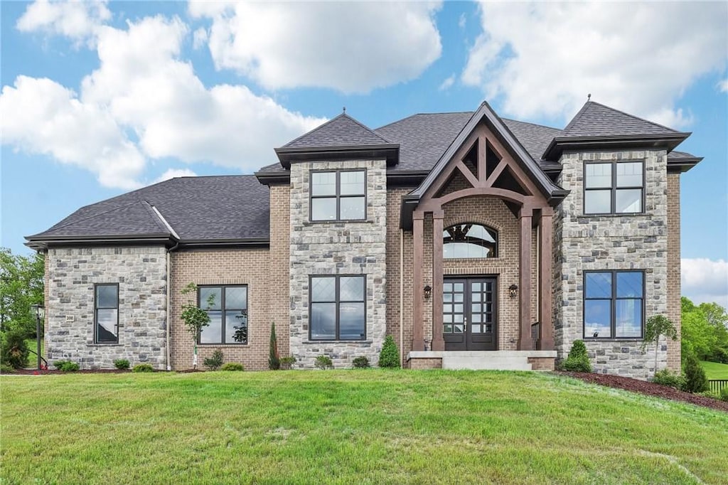 view of front of home featuring a front yard and french doors