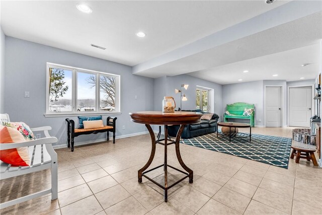 interior space with light tile patterned floors and a healthy amount of sunlight