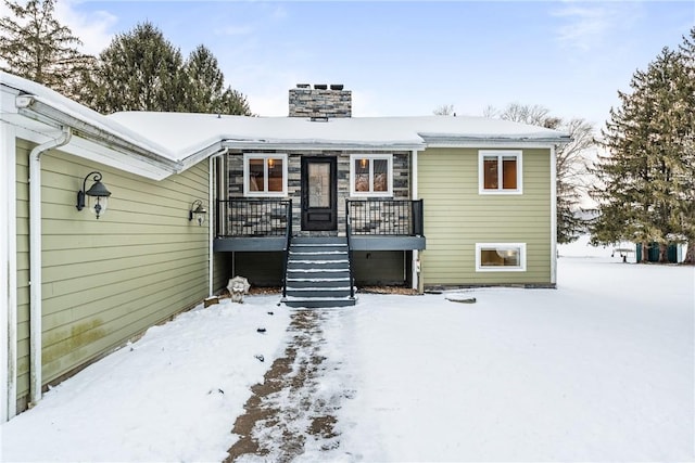 view of snow covered rear of property