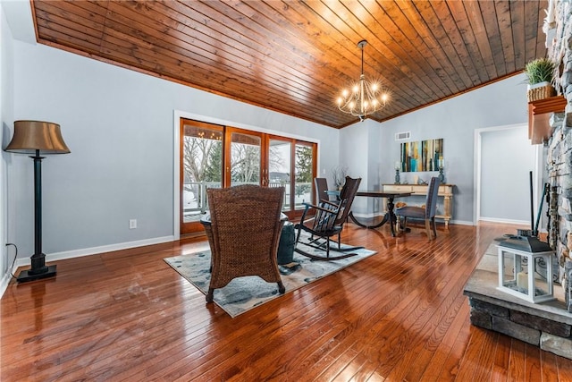 living room featuring wood ceiling, crown molding, a chandelier, and hardwood / wood-style flooring