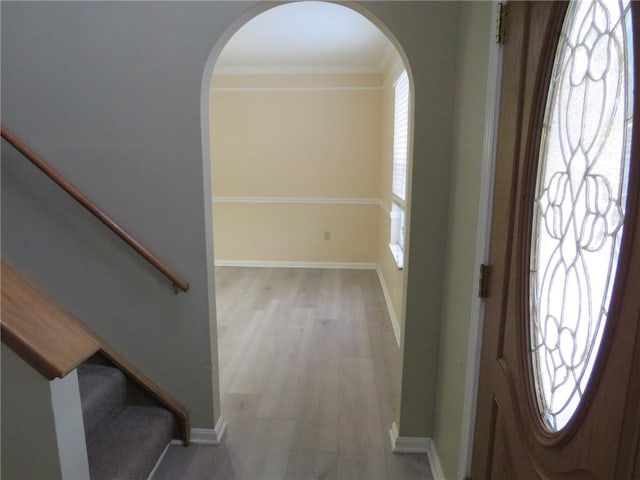 entrance foyer with plenty of natural light, baseboards, and wood finished floors