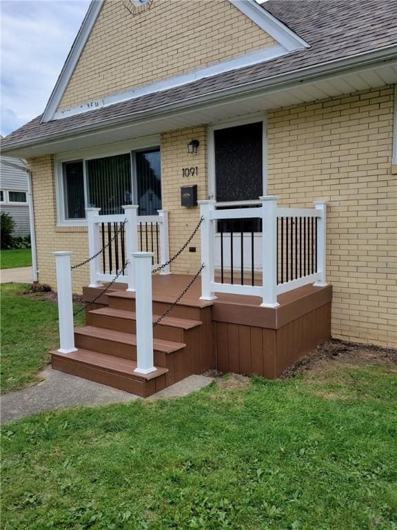 property entrance with a lawn