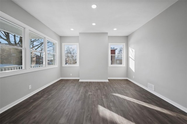 unfurnished room with dark hardwood / wood-style floors