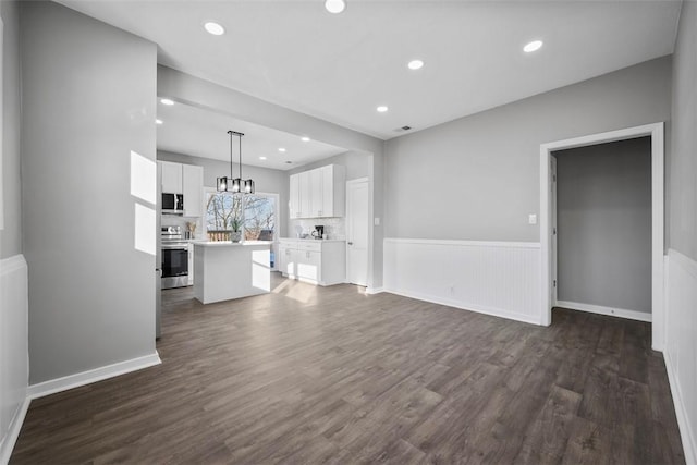 unfurnished living room featuring dark wood-type flooring