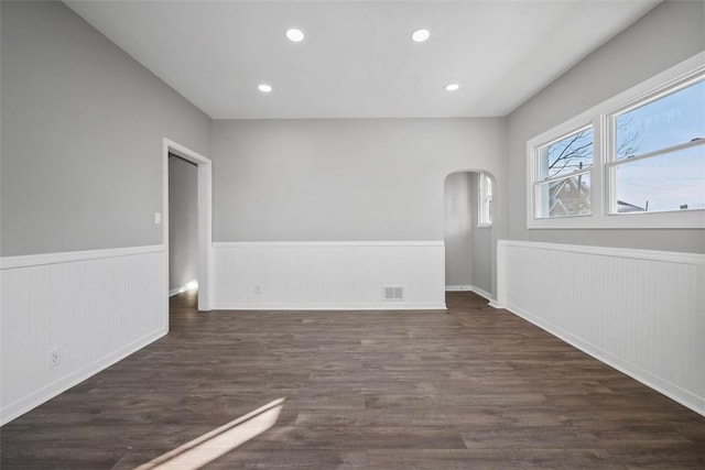 unfurnished room with dark hardwood / wood-style floors