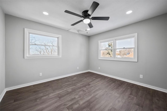 spare room featuring ceiling fan, dark hardwood / wood-style flooring, and a wealth of natural light