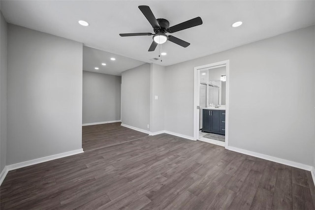 unfurnished room with ceiling fan and dark hardwood / wood-style floors