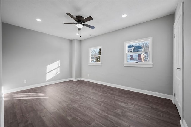 spare room with dark hardwood / wood-style floors and ceiling fan