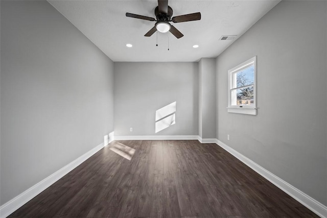 spare room featuring dark hardwood / wood-style flooring and ceiling fan