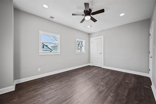 spare room with dark wood-type flooring and ceiling fan