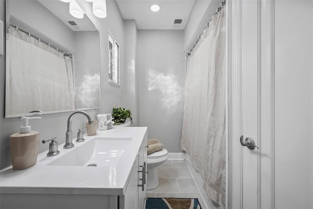 bathroom with vanity, walk in shower, tile patterned floors, and toilet