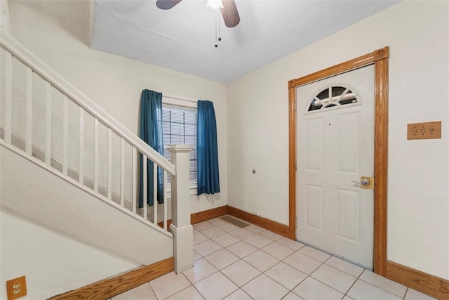 tiled foyer featuring ceiling fan