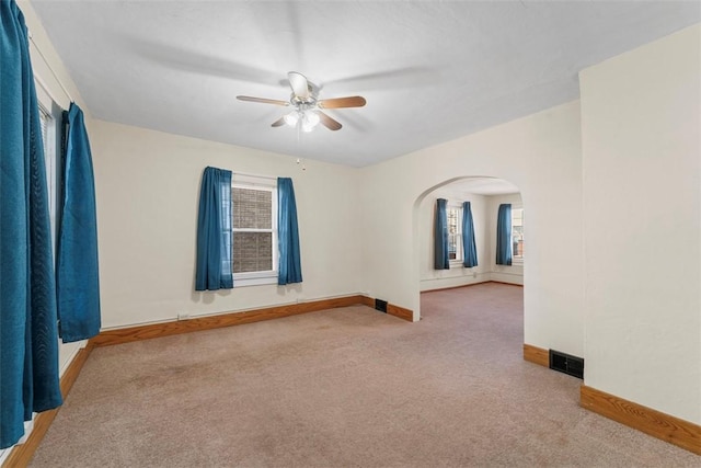 carpeted empty room featuring ceiling fan