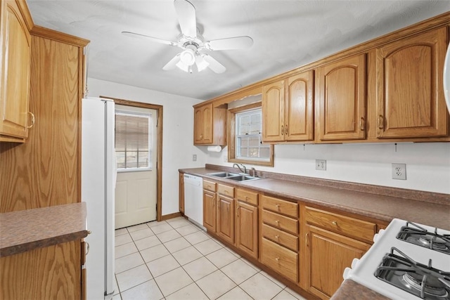 kitchen with light tile patterned flooring, white appliances, ceiling fan, and sink