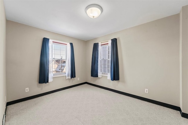 spare room featuring light colored carpet