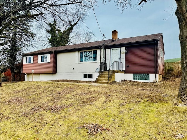 back of house featuring a yard