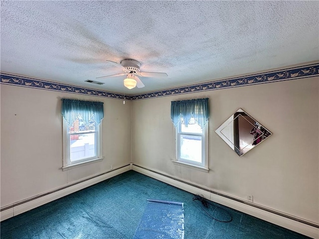 empty room with ceiling fan, carpet floors, and a textured ceiling