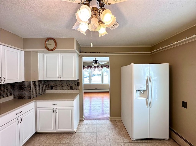 kitchen featuring white cabinetry, white fridge with ice dispenser, ceiling fan, and baseboard heating