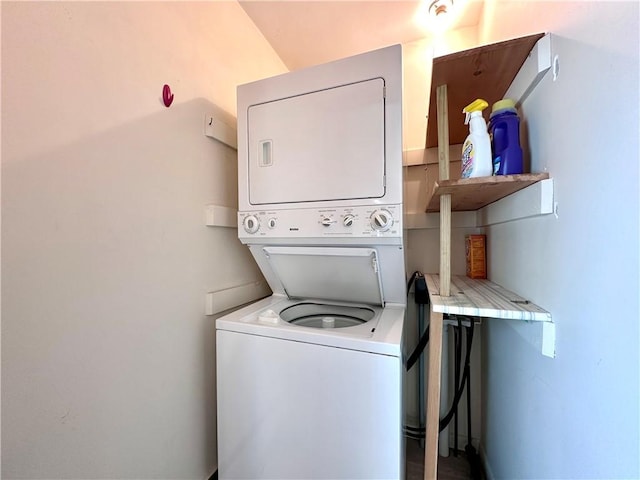 clothes washing area with stacked washer and dryer