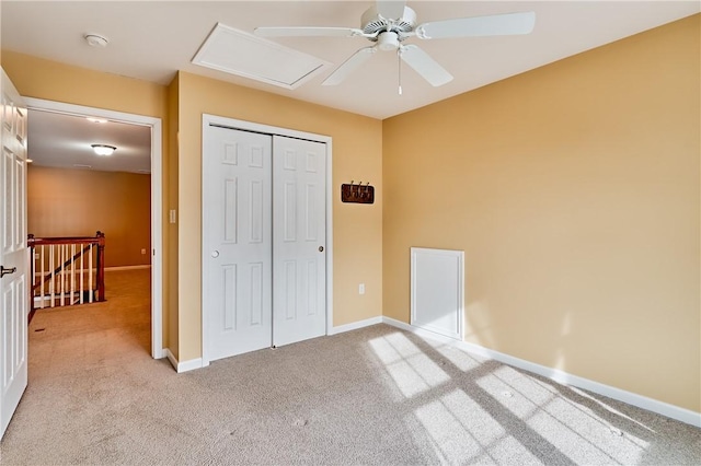 unfurnished bedroom featuring light carpet, a closet, and ceiling fan