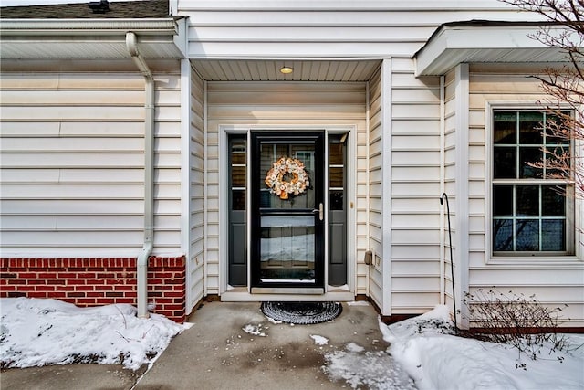 view of snow covered property entrance