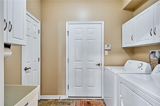 laundry area with cabinets and washing machine and clothes dryer