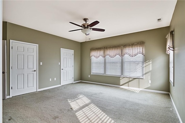 carpeted empty room with ceiling fan