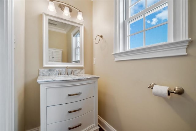 bathroom with vanity and ornamental molding